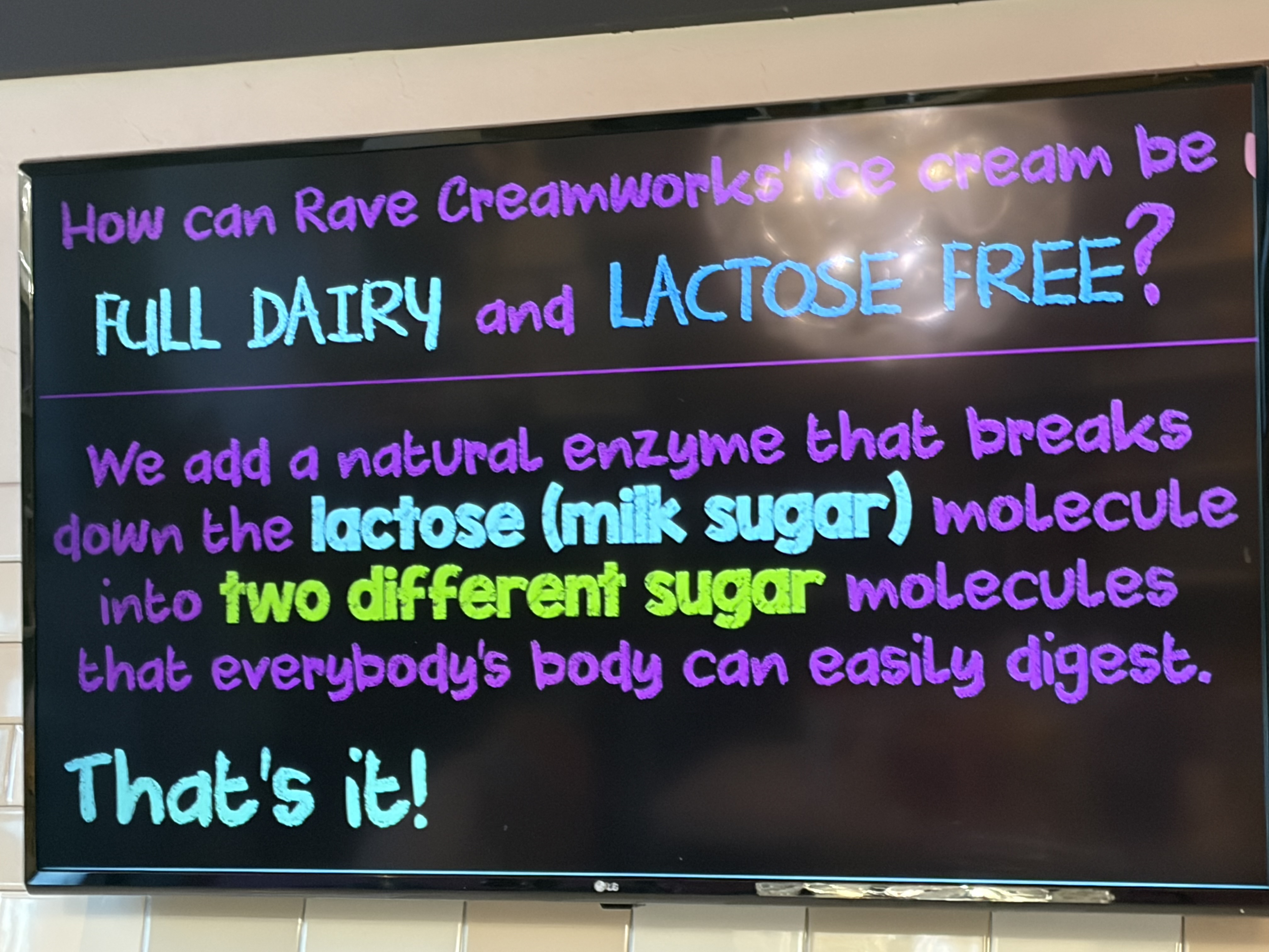 A colorful sign at Rave Creamworks explaining how lactase is added to make ice cream lactose free